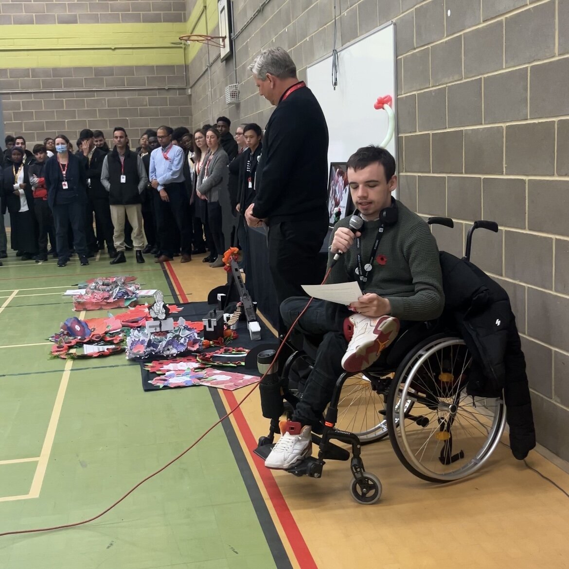 Student Governor, Mickey reading In Flanders Fields